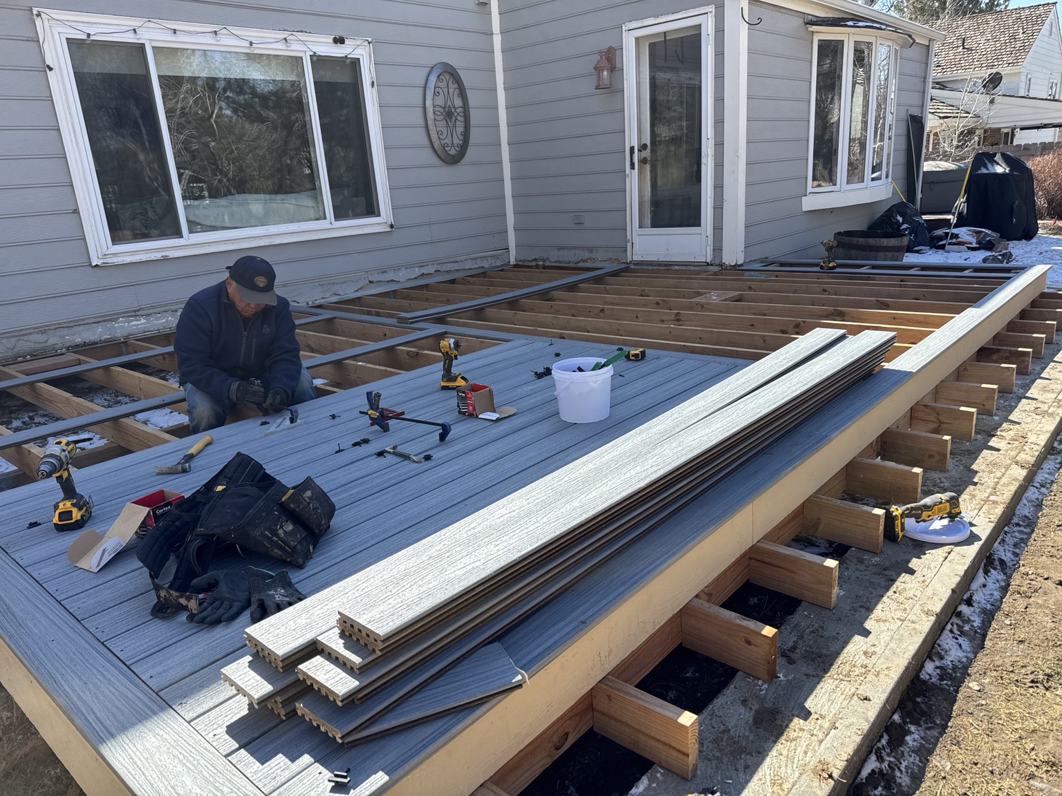 Construction worker working on elevated deck framing